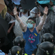 A student protester in Hong Kong tries to negotiate with riot police as they fire pepper spray in to the crowd on Sunday, Sept. 28, 2014.